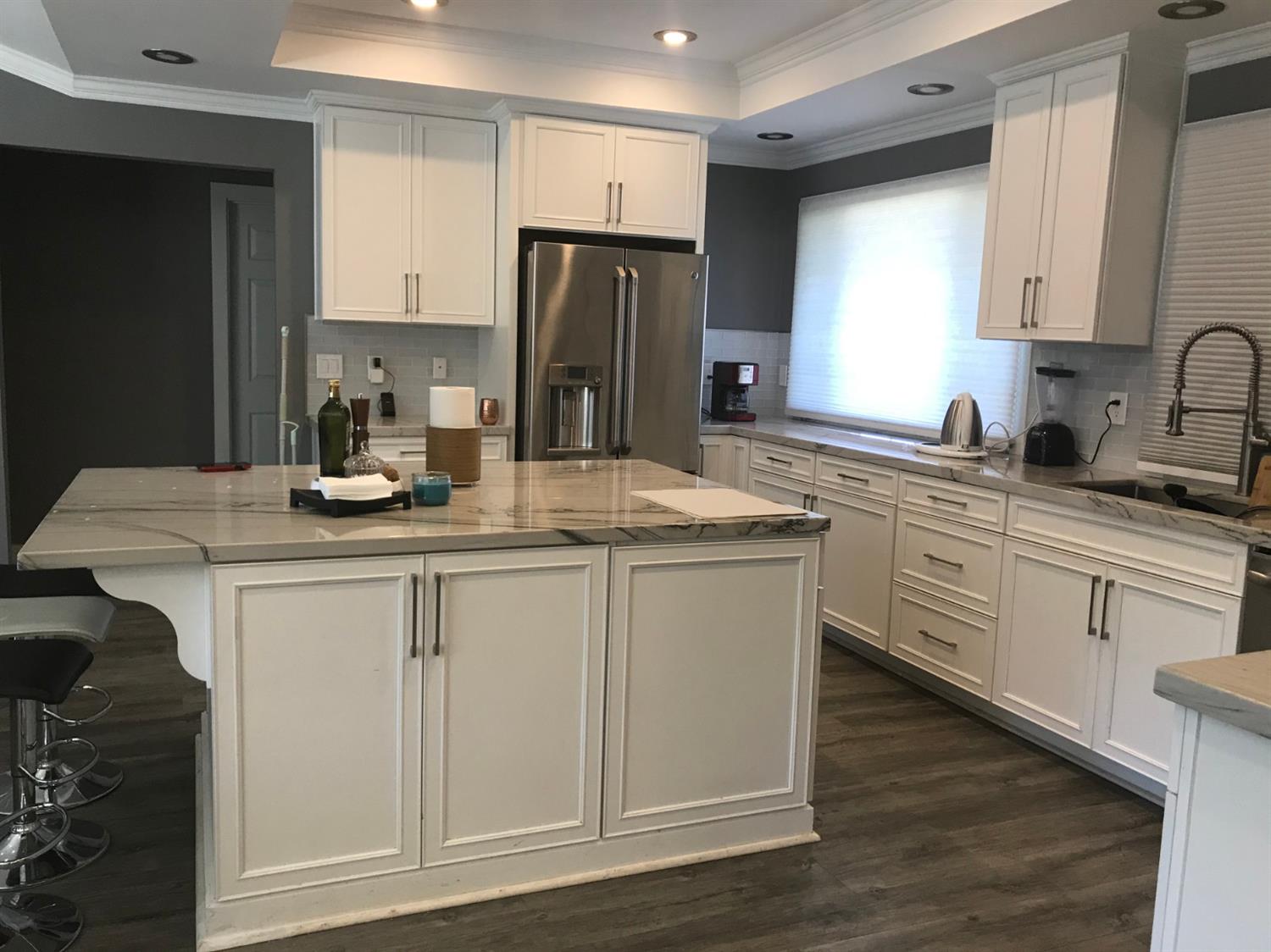 4448 Hackberry Lane Carmichael, CA 95608 - Photo 21 of 64 a kitchen with stainless steel appliances granite countertop a sink stove refrigerator and cabinets