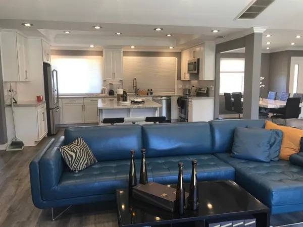 a living room with furniture and kitchen view