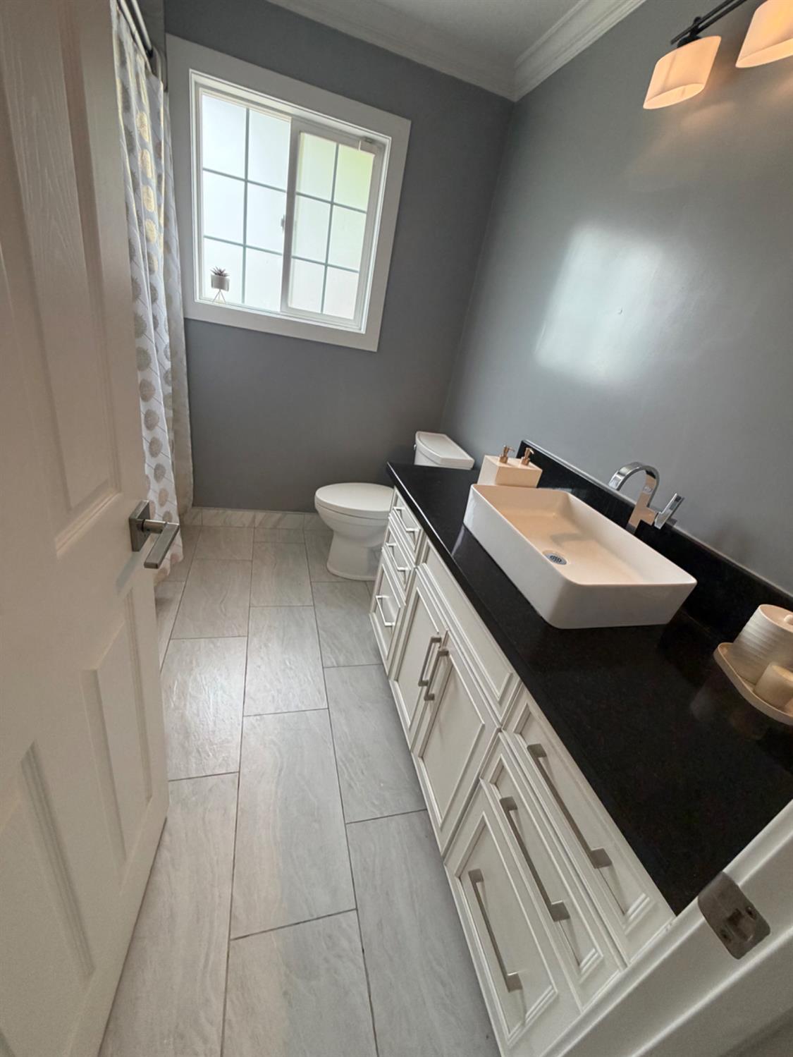 4448 Hackberry Lane Carmichael, CA 95608 - Photo 47 of 64 a bathroom with a sink a toilet and a window