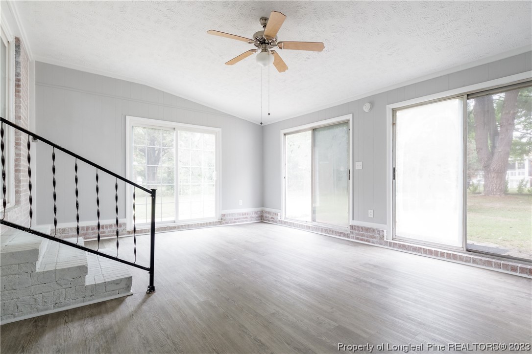 1412 Milton Street Spring Lake, NC 28390 - Photo 16 of 27 a view of an empty room with window a ceiling fan and windows
