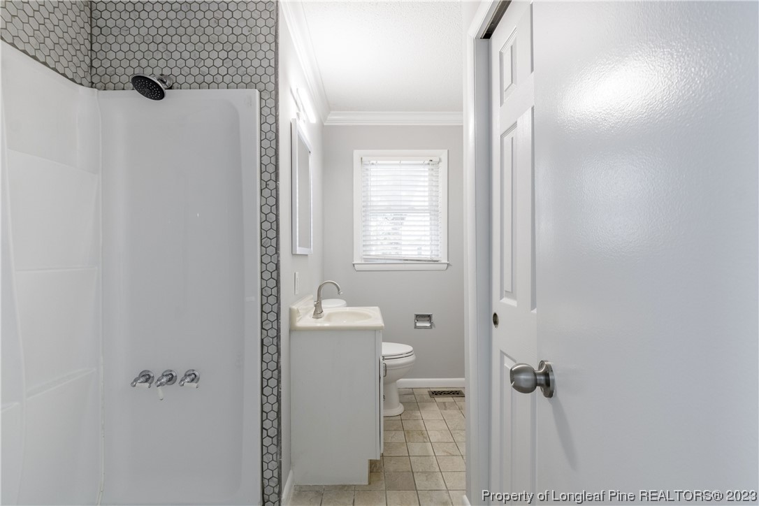 1412 Milton Street Spring Lake, NC 28390 - Photo 18 of 27 a bathroom with a shower