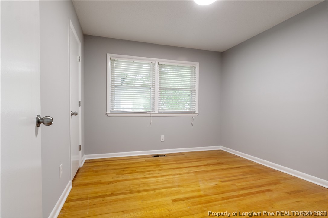 1412 Milton Street Spring Lake, NC 28390 - Photo 20 of 27 a view of a room with wooden floor and windows