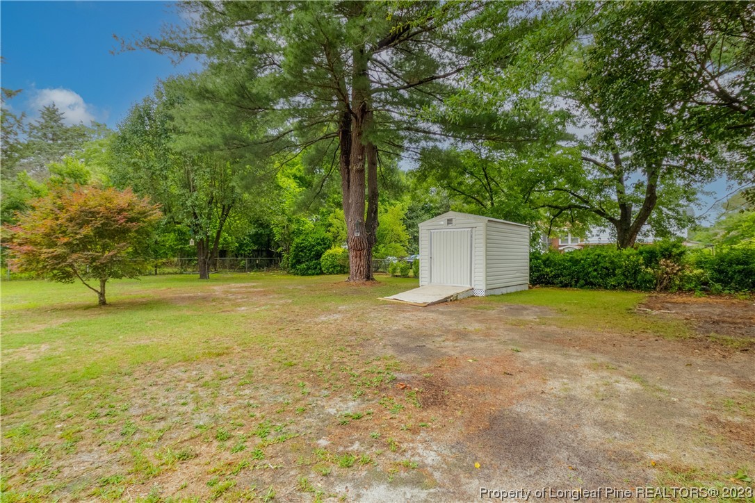 1412 Milton Street Spring Lake, NC 28390 - Photo 26 of 27 a backyard of a house with large trees