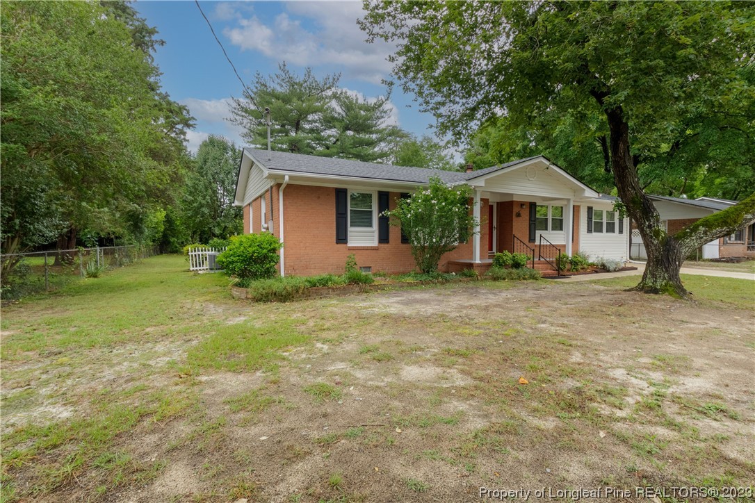 1412 Milton Street Spring Lake, NC 28390 - Photo 3 of 27 a front view of a house with garden