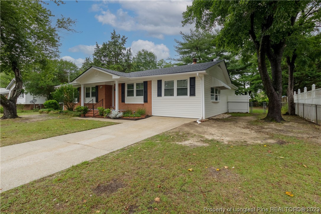 1412 Milton Street Spring Lake, NC 28390 - Photo 4 of 27 a front view of a house with garden