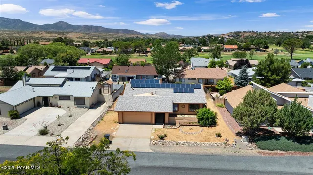 an aerial view of a houses with a street