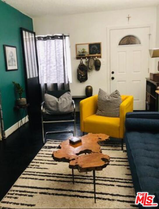 815 Pacific Avenue, Unit 9 Long Beach, CA 90813 - Photo 2 of 25 a living room with furniture and a rug
