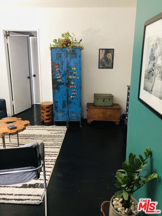 815 Pacific Avenue, Unit 9 Long Beach, CA 90813 - Photo 5 of 25 a bedroom with a bed and a table in it