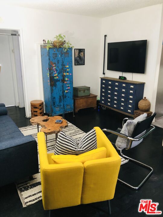815 Pacific Avenue, Unit 9 Long Beach, CA 90813 - Photo 7 of 25 a living room with furniture and a flat screen tv
