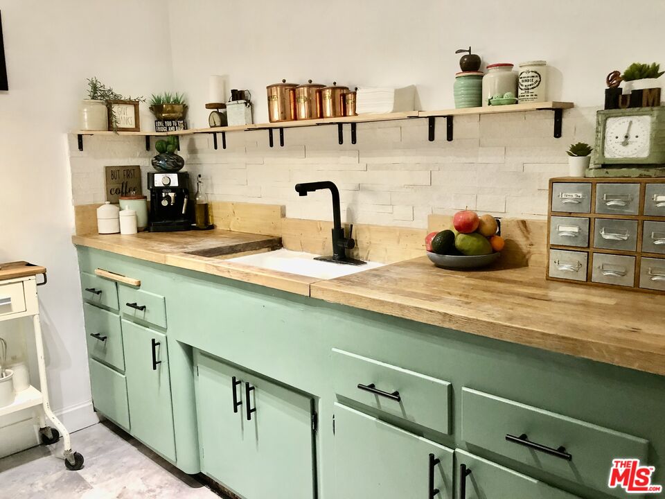 815 Pacific Avenue, Unit 9 Long Beach, CA 90813 - Photo 10 of 25 a kitchen with a sink and cabinets