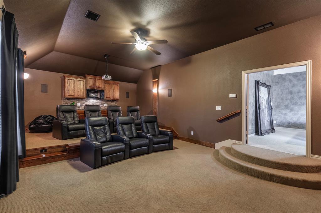 1217 Windmere Way Allen, TX 75013 - Photo 29 of 38 Stadium-style seating, surround sound, and a built-in refreshment station turn movie nights into a true cinematic experience.