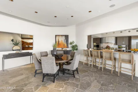 a large kitchen with stainless steel appliances granite countertop a refrigerator and a sink