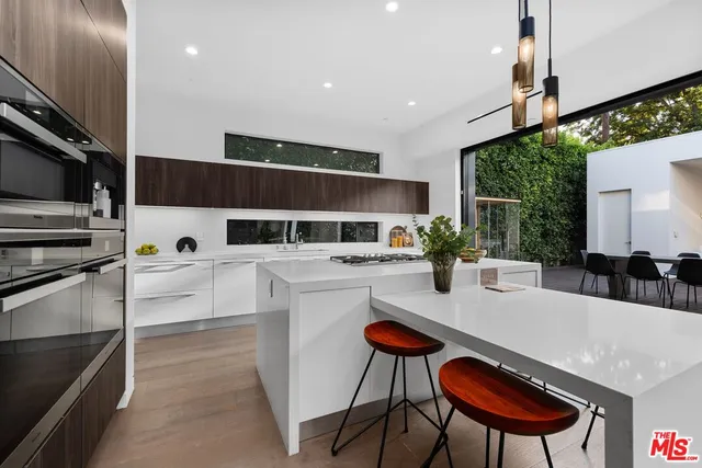 a large kitchen with stainless steel appliances