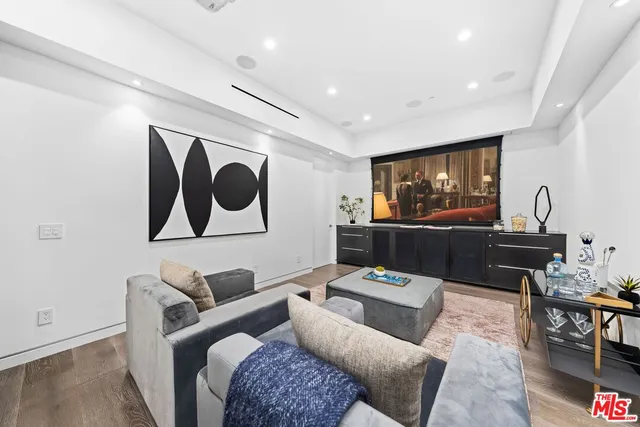 a large bedroom with a bed and a flat screen tv