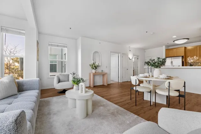 a living room with furniture and a wooden floor