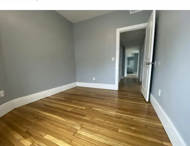 wooden floor in an empty room with a fireplace