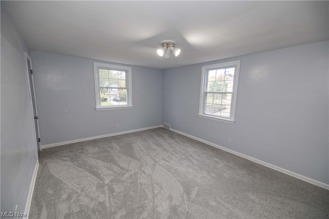 4591 Birchwold Road South Euclid, OH 44121 - Photo 18 of 35 Empty room with a wealth of natural light and light carpet