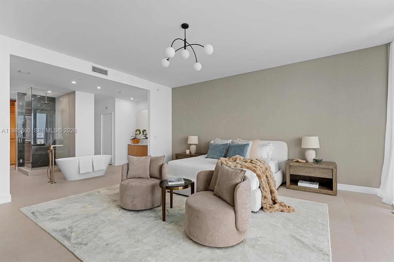 700 Northeast 24th Street, Unit PH5802 Miami, FL 33137 - Photo 11 of 59 a spacious bedroom with bed and a chandelier