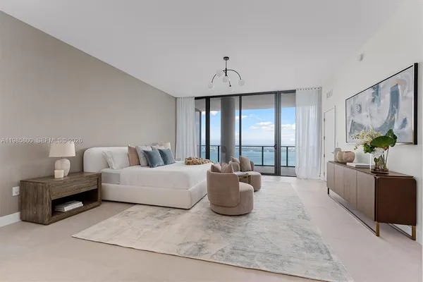 a bedroom with a bed couch and window