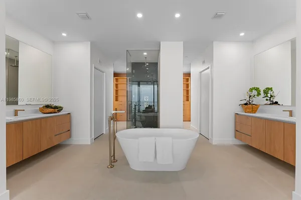 a spacious bathroom with a tub shower vanity and sink