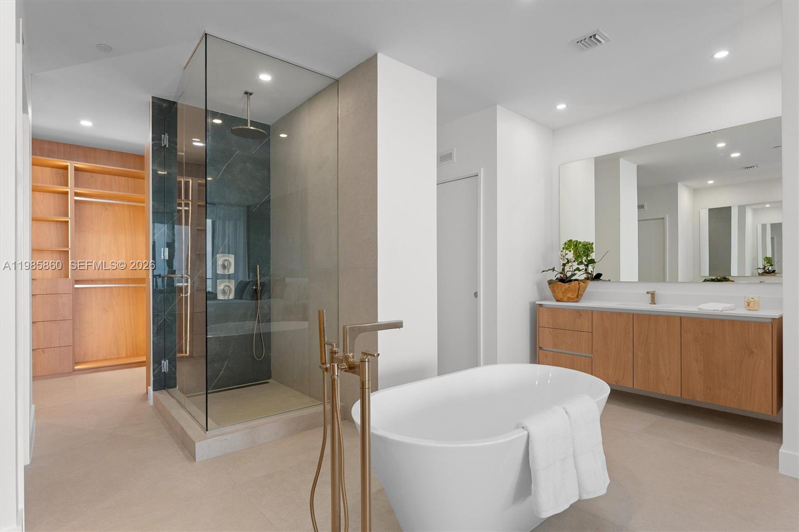 700 Northeast 24th Street, Unit PH5802 Miami, FL 33137 - Photo 16 of 59 a spacious bathroom with a tub shower vanity and sink