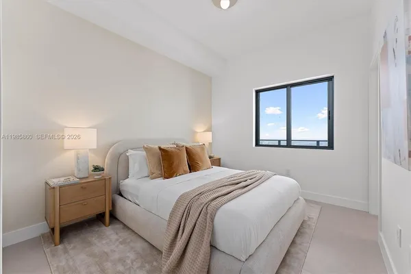 a bedroom with a bed and a lamp