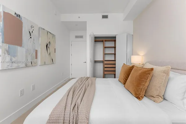 a bedroom with a bed and a mirror