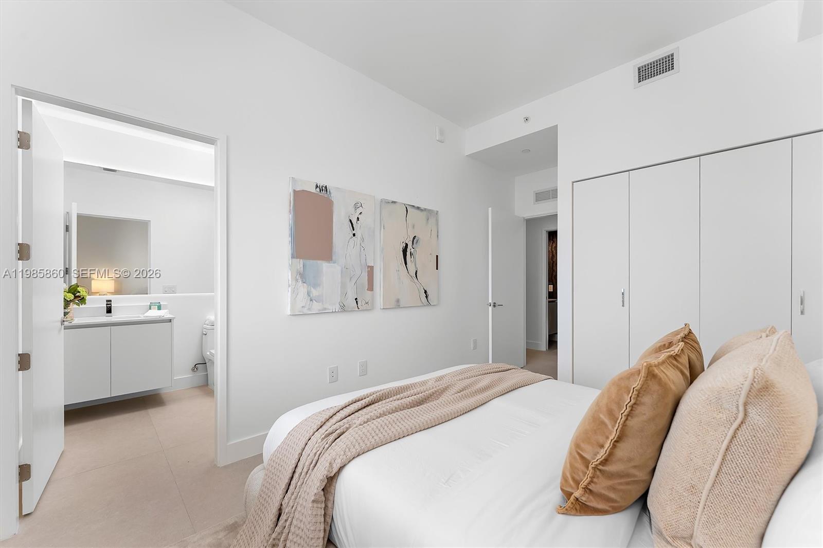 700 Northeast 24th Street, Unit PH5802 Miami, FL 33137 - Photo 21 of 59 a bedroom with a bed and a mirror