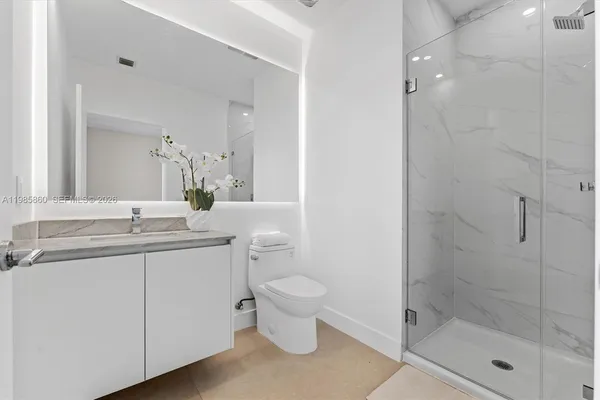 a view of a hallway with closet and a shower