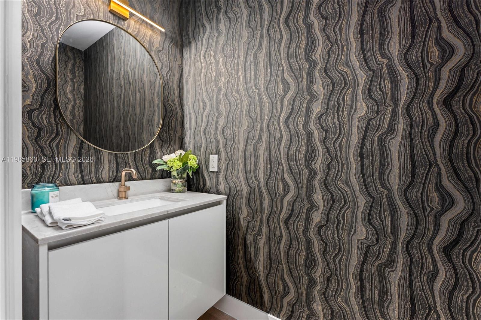 700 Northeast 24th Street, Unit PH5802 Miami, FL 33137 - Photo 24 of 59 a bathroom with a sink and a mirror