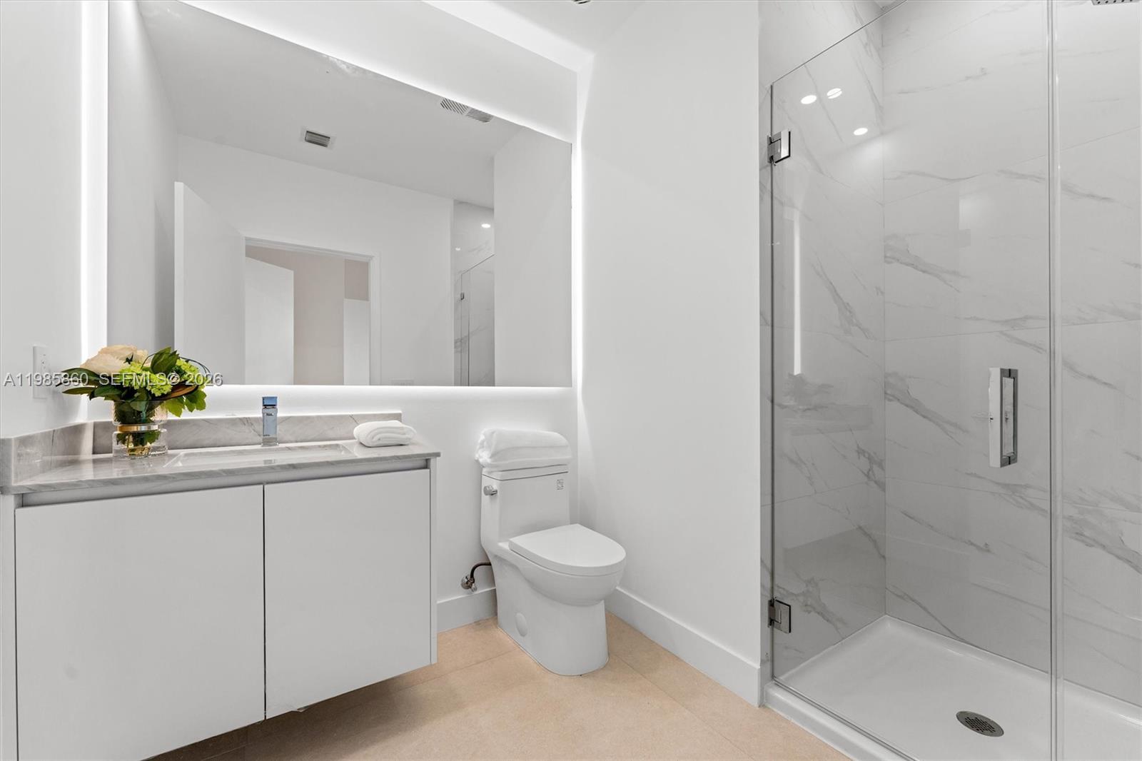 700 Northeast 24th Street, Unit PH5802 Miami, FL 33137 - Photo 29 of 59 a bathroom with a sink a toilet and a shower