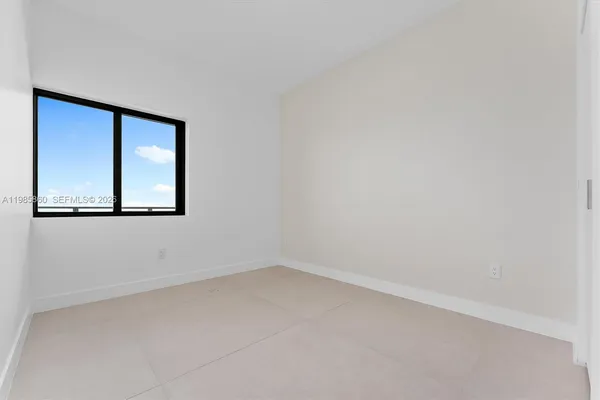 a view of room with balcony and a closet