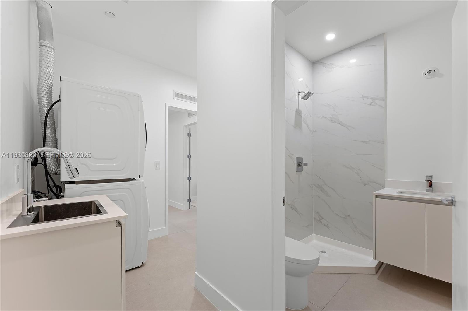 700 Northeast 24th Street, Unit PH5802 Miami, FL 33137 - Photo 32 of 59 a bathroom with a sink a toilet and shower