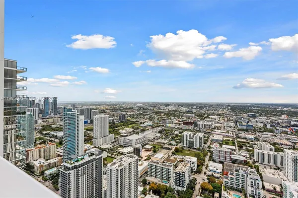 a living room with furniture and potted plant