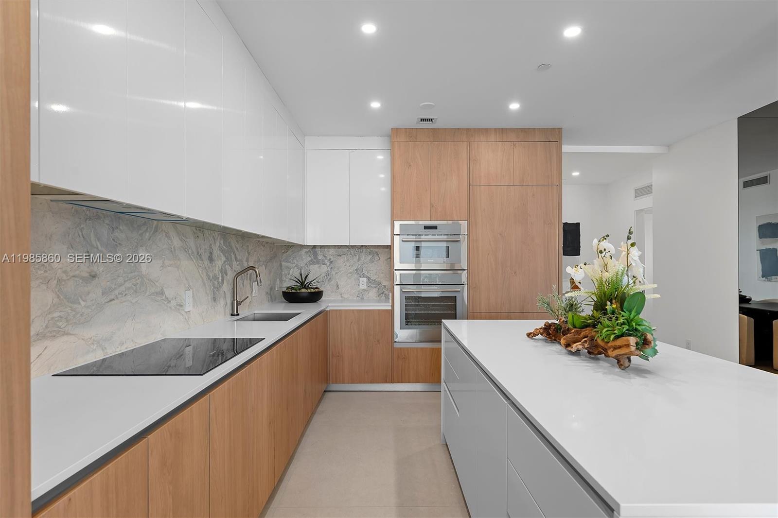 700 Northeast 24th Street, Unit PH5802 Miami, FL 33137 - Photo 7 of 59 a large kitchen with stainless steel appliances a sink stove and cabinets