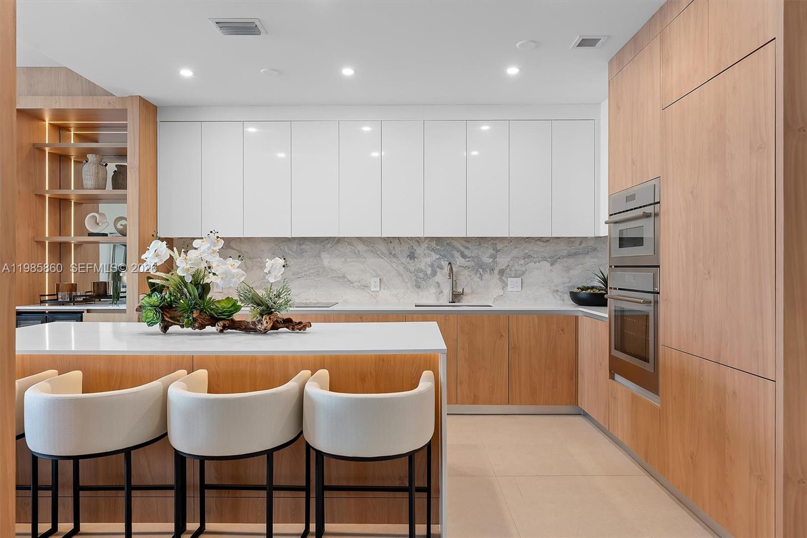 700 Northeast 24th Street, Unit PH5802 Miami, FL 33137 - Photo 9 of 59 a kitchen with granite countertop white cabinets and stainless steel appliances