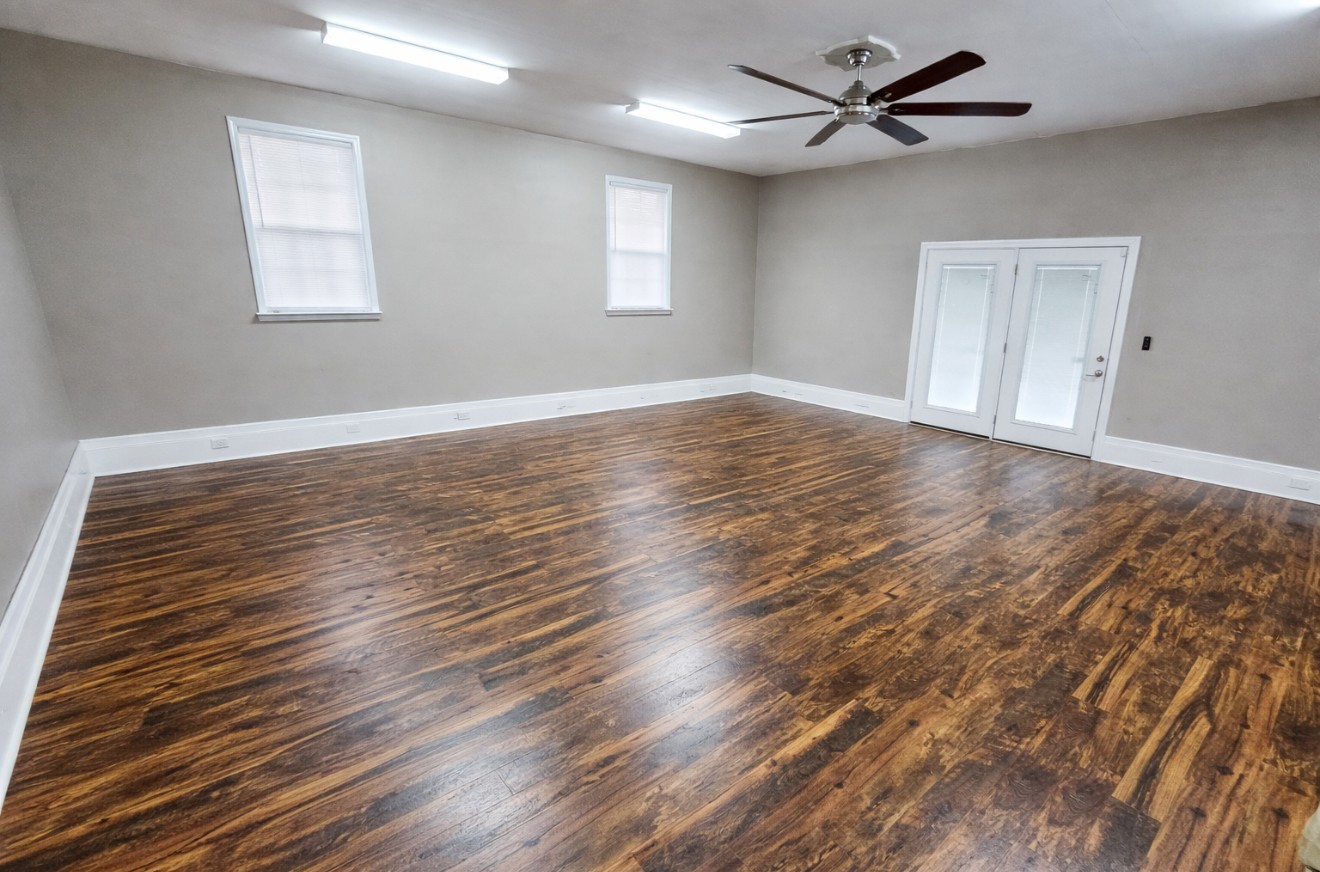 223 Rich Road Unionville, TN 37180 - Photo 26 of 31 an empty room with wooden floor ceiling fan and windows