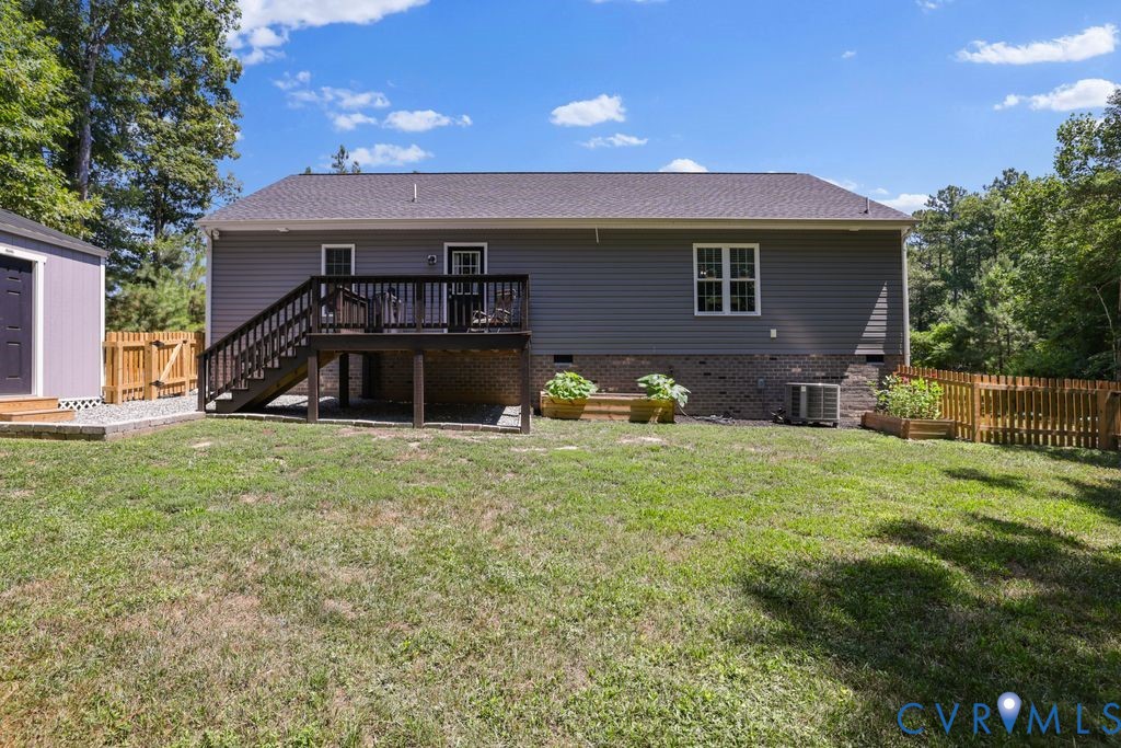 222 Oak Ridge Court Aylett, VA 23009 - Photo 32 of 35 Expansive backyard with a grey vinyl-sided exterio