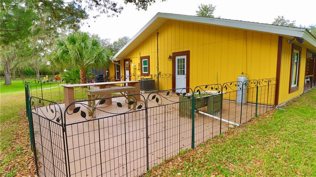 4873 Old Ranch Road Sarasota, FL 34241 - Photo 44 of 49 Dog run for small dogs, and door to the master bedroom on the east side of the house.