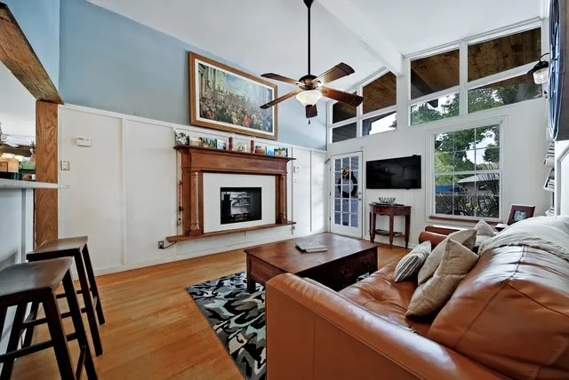 a living room with furniture a flat screen tv and a fireplace
