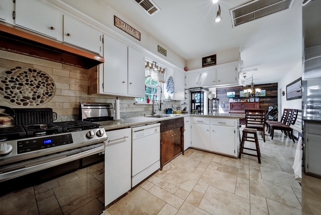 7031 Triola Lane Houston, TX 77074 - Photo 9 of 12 a kitchen with appliances cabinets and a sink