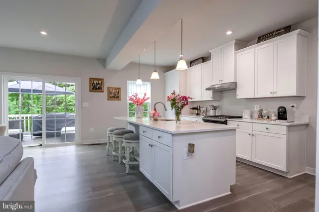 a kitchen with stainless steel appliances a sink and cabinets