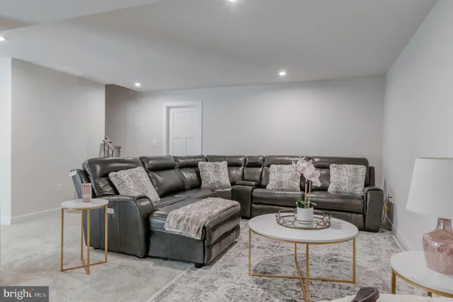 a front view of a house with garden and parking