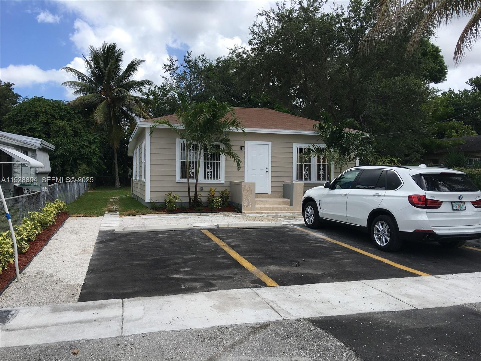 a view of a car parked in front of house