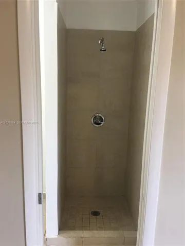 a bathroom with a glass shower door