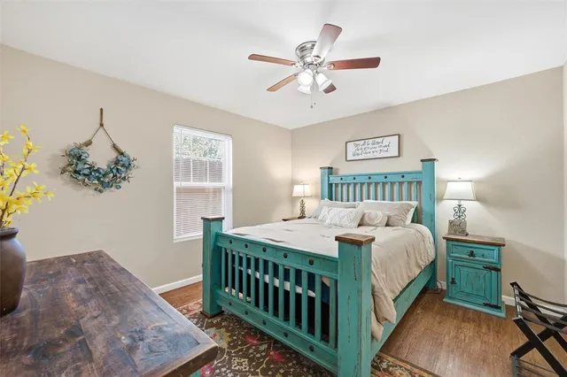 a bedroom with a bed a chandelier and dresser
