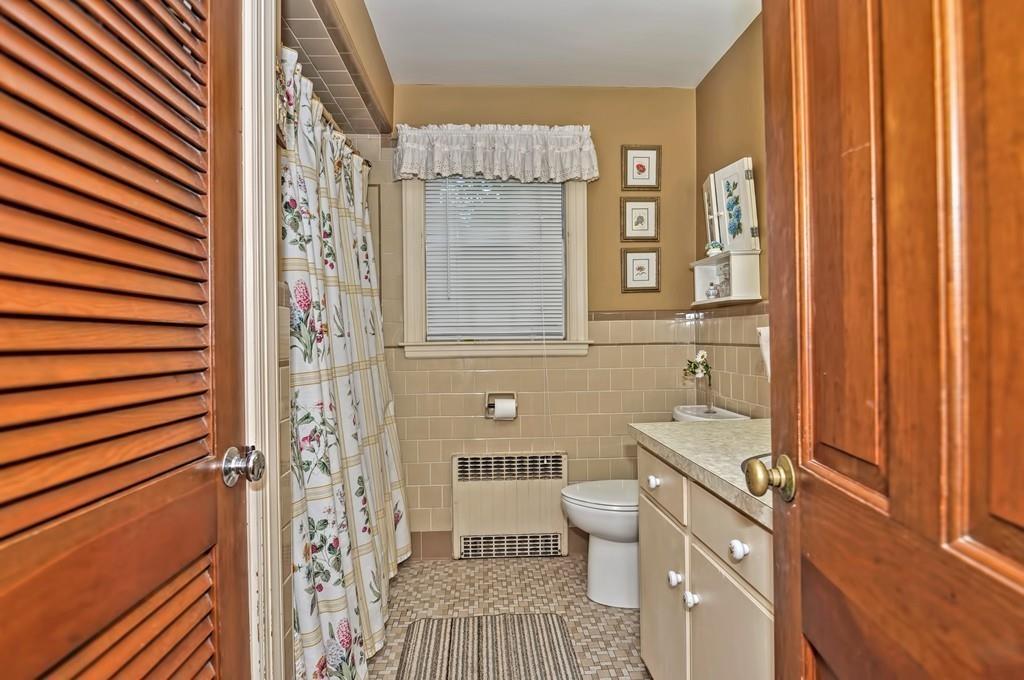 7 Rosedale Drive Bristol, RI 02809 - Photo 18 of 23 a bathroom with a sink a toilet and shower curtain