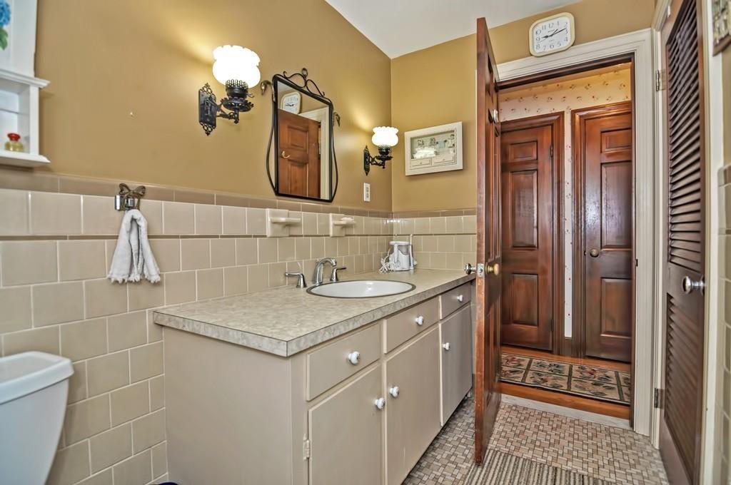 7 Rosedale Drive Bristol, RI 02809 - Photo 19 of 23 a bathroom with a granite countertop sink a mirror and shower