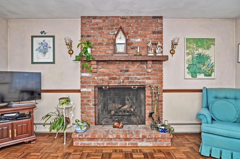 7 Rosedale Drive Bristol, RI 02809 - Photo 9 of 23 a living room with furniture a fireplace and a flat screen tv