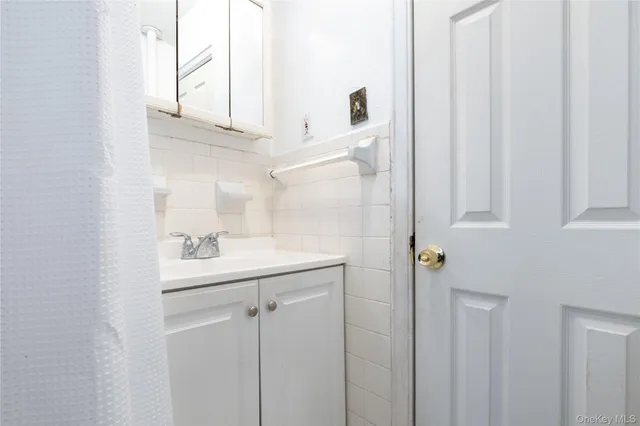a bathroom with a sink a mirror and shower